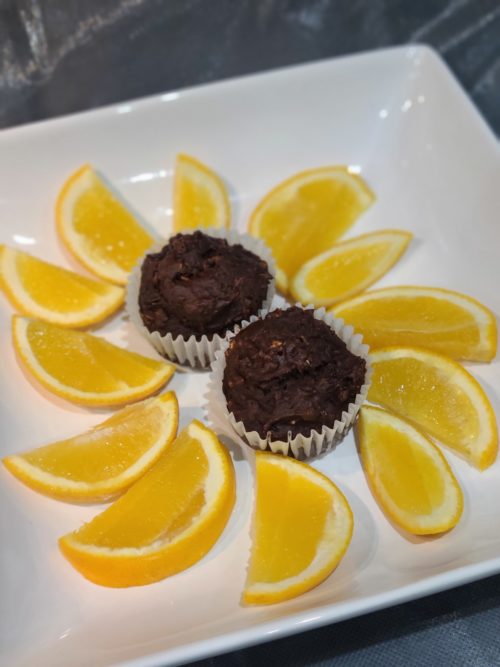 Plate of oranges and cupcakes